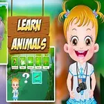 Dievčatko s blond vlasmi a fotoaparátom na krku stojí vedľa ilustrácie so zvieratami v prírode a nápisom Learn Animals