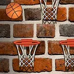 Basketbalová lopta a tri basketbalové koše na tehlovom múre