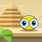 Žltá guľatá tvár s veľkými modrými očami pred pyramídami na púšti