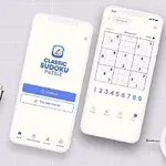 Dva biele smartfóny zobrazujú aplikáciu s úlohou sudoku, obklopené perom, hodinkami a rastlinou