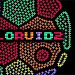 Farebný nápis COLORUID2 uprostred geometrického pozadia zloženého z rôznofarebných pixelových vzorov na čiernom pozadí