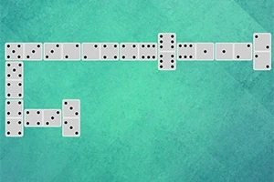 Domino kocky usporiadané na zelenom pozadí v tvare pravého uhla
