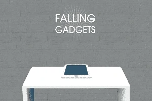 Tablet leží na bielom stole pred sivou tehlovou stenou s textom Falling Gadgets nad ním