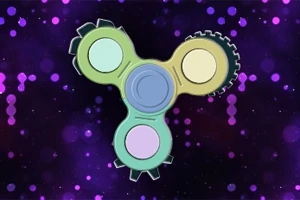 Farebný fidget spinner s ozubenými kolieskami na fialovom pozadí s bublinkovými vzormi