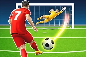 Futbalista v červenom drese kope loptu do brány, zatiaľ čo brankár v žltom skáče, aby loptu chytil