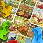 Farebná hracia doska s ilustrovanými štvorecmi a figúrkami v tvare kačíc