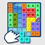 Ruka ukazujúca na viacfarebné bloky s rôznymi symbolmi v mriežke