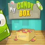 Veselý zelený postavičkový charakter vedľa kartónovej krabice s cukríkmi a nápisom My Candy Box na pozadí