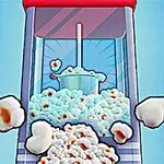 Popcorn vychádzajúci z popcornovača s modro-červeným krytom na modrom pozadí