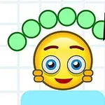 Usmievajúci sa emoji s modrými očami a ružové líca, nad ktorým sú zelené guličky a ceruzka