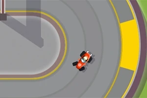 Pohľad zhora na červenú motokáru jazdiacu po závodnej trati s farebnými označeniami