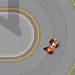 Pohľad zhora na červenú motokáru jazdiacu po závodnej trati s farebnými označeniami