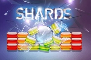 Farebná rozbitá stena zložená z oranžových, žltých a zelených blokov na modrom pozadí s nápisom „SHARDS“