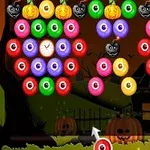 Farebné guľôčky a halloweenové prvky na tmavom pozadí s domom a tekvicami