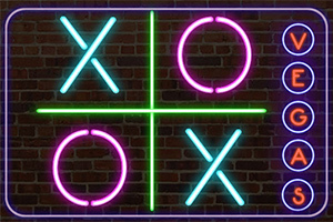 Neónové znaky X a O s nápisom VEGAS na tehlovom pozadí