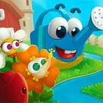 Usmievavá modrá kanva s veľkými očami obklopená farebnými kvetmi v záhrade